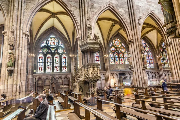 Beautiful windows of the minster show religious scenes from the — Stock Photo, Image