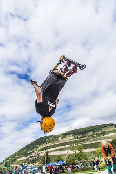 Teen jumps with scooter over a ramp and performs a salto — Stock Photo, Image