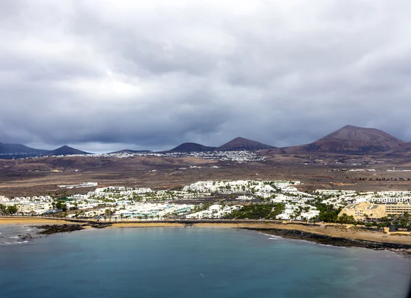 Aerial of Arrecife with volcanoes in clouds — Stock Photo, Image