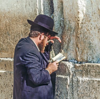 Orthodox jewish man prays at the Western Wall  clipart