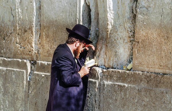 Orthodox jewish man prays at the Western Wall 