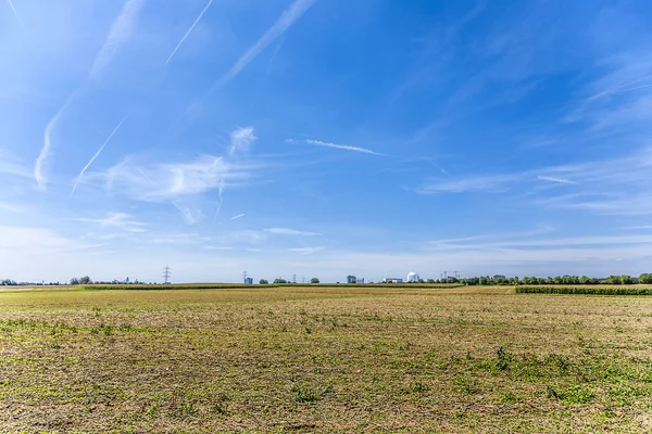 Acres after harvest under blue sky — Stock Photo, Image