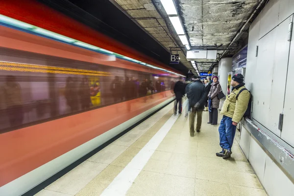 As pessoas esperam na estação de metro para o trem que chega — Fotografia de Stock