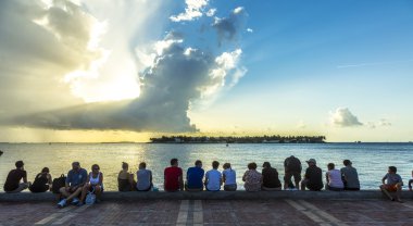 people enjoy the sunset point at Mallory square in Key Wes clipart