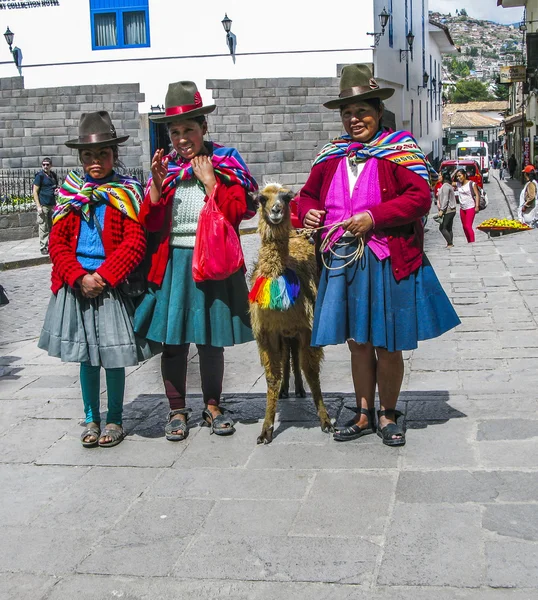 Indisk kvinna poserar med en lama för turister i Cuzco — Stockfoto
