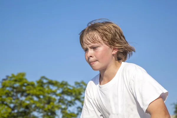 Detail of face of boy with scooter in action — Stock Photo, Image