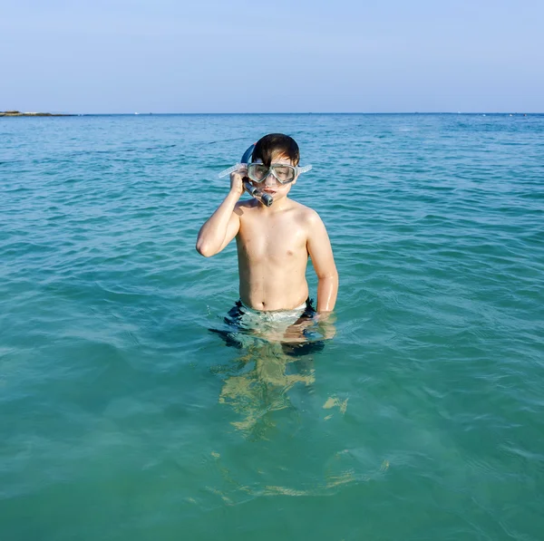 genç çocuk su sahiptir ve şnorkel başlar