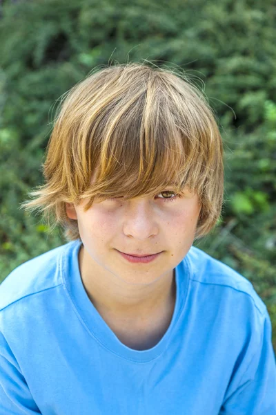 Smart boy sitting on a bench — Stock Photo, Image