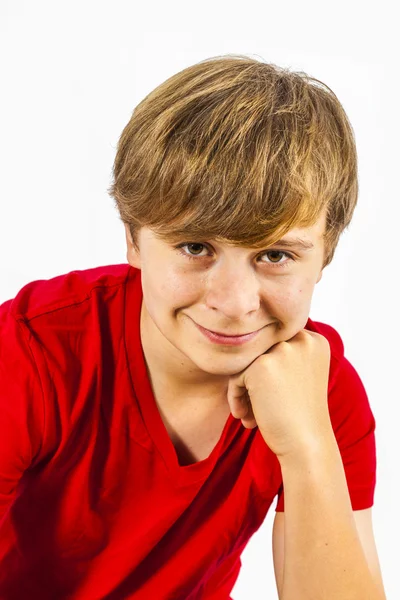 Cute boy leans on his head with his arm — Stock Photo, Image