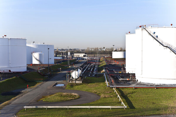 white tanks in tank farm with blue sky