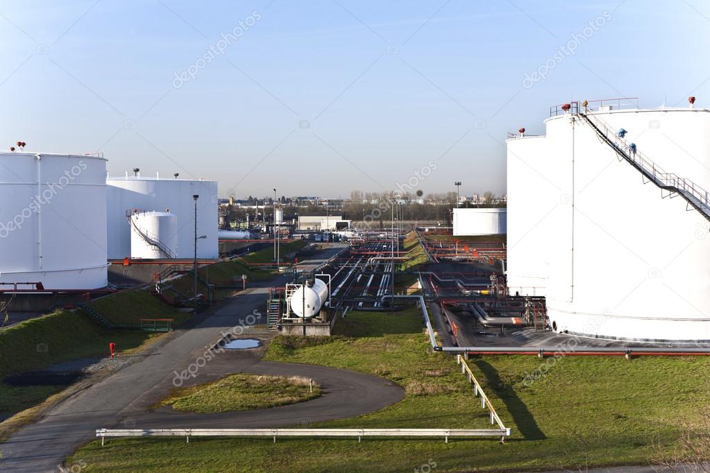 white tanks in tank farm with blue sky