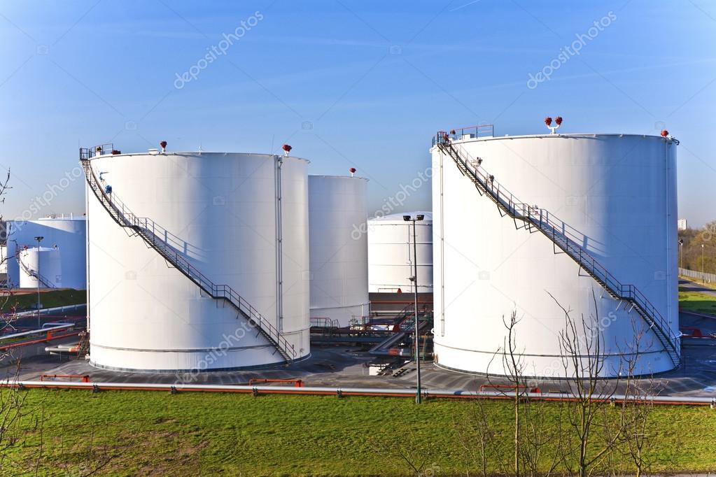 white tanks in tank farm with blue sky