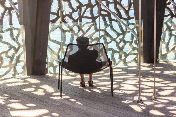 Lady relaxes at Museum of European and Mediterranean Civilizatio — Stock Photo, Image