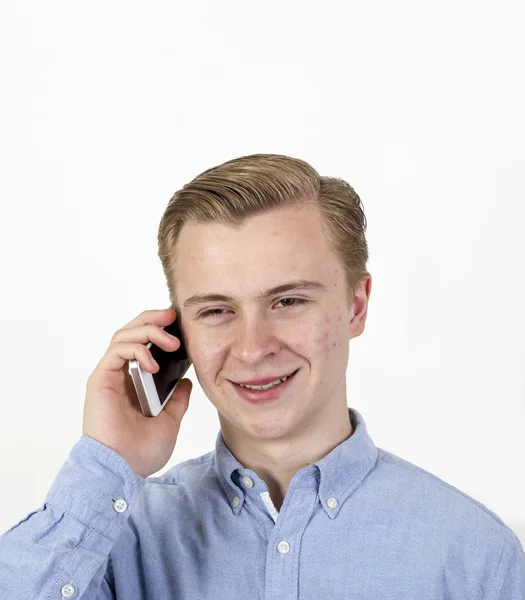 Menino adolescente bonito em um celular — Fotografia de Stock