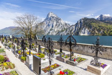 old cemetery at the church yard with mountain view clipart