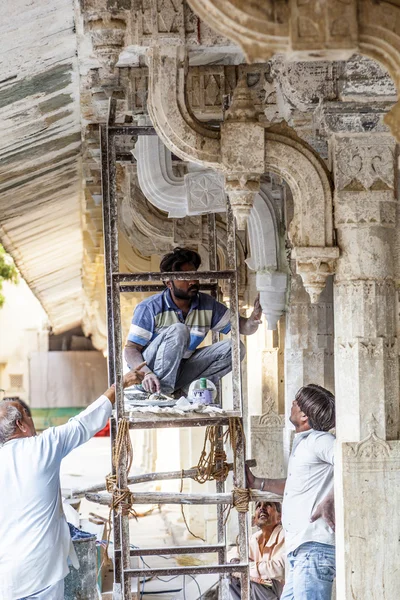 労働者はウダイプールの都市宮殿のファサードを修復します。 — ストック写真