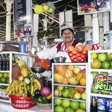 friendly local woman sells fresh juices to tourists