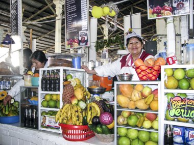 friendly local woman sells fresh juices to tourists