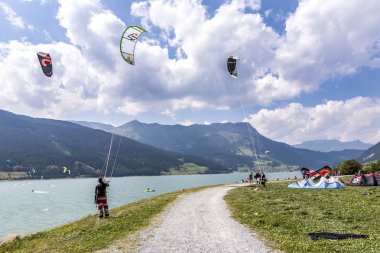 people enjoy windsurfing at lake Levico in Latsch