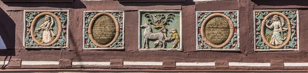 Traditional carving at an half timbered house with symbols — Stock Photo, Image