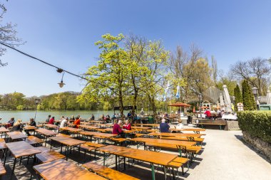 people enjoy the beautiful weather at the   Seehaus in Munich clipart