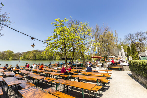 people enjoy the beautiful weather at the   Seehaus in Munich