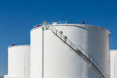 Enerji sembolü olarak gün ışığında beyaz benzin siloları