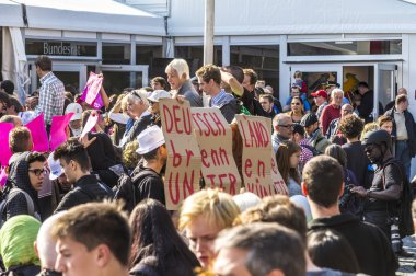 people demonstrate against the celebration of 25th day of German