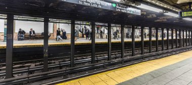 People wait at subway station Wall street
