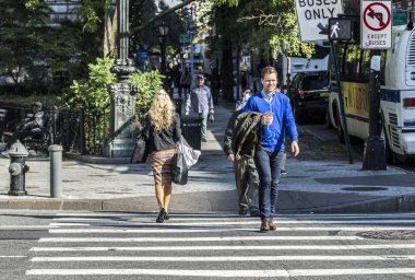 people crossing a street at a pedestrian crossing in New York