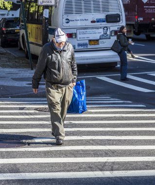 people crossing a street at a pedestrian crossing in New York
