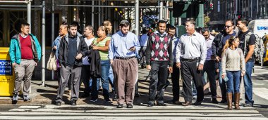 people crossing a street at a pedestrian crossing in New York