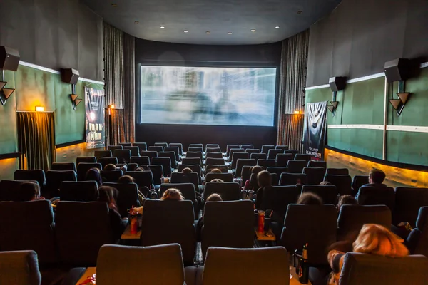 children enjoy a film at an old traditional cinema 
