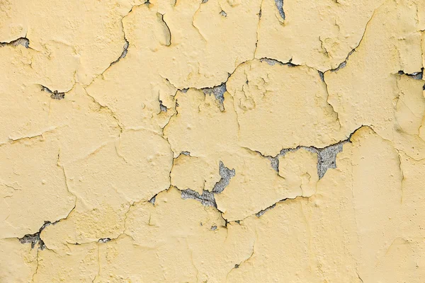 Peeling van gele en witte verf op een ruw oppervlak — Stockfoto