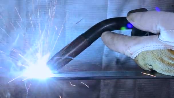 Metal Worker Welds Piece Steel Generating Blue Flames Sparks — Stock Video