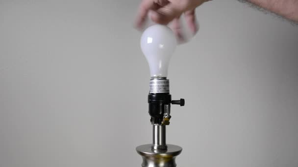 Man Changes Traditional General Purpose Light Bulb Replaces New Compact — Stock Video