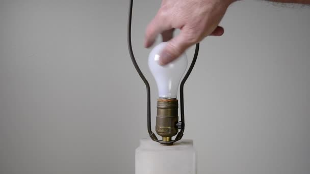 Man Changes Traditional General Purpose Light Bulb Replaces Another Fresh — Stock Video