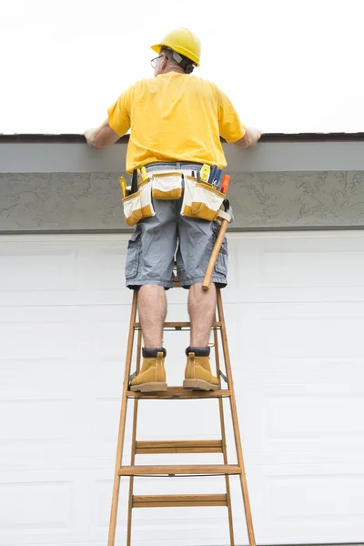 Contractor standing on ladder — Stock Photo, Image