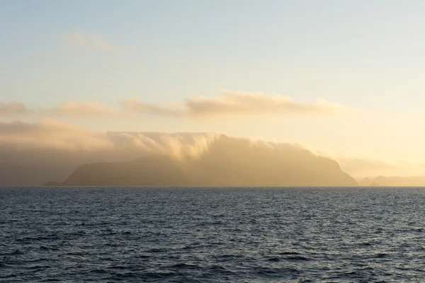 Clouds covering island — Stock Photo, Image