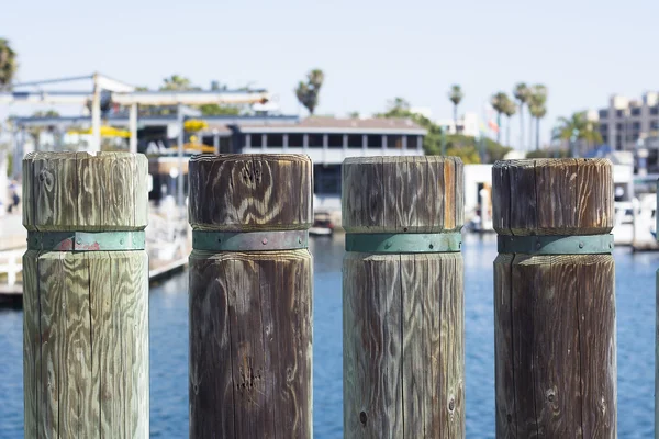 Pier pylons on a harbor boardwalk — Stock Photo, Image
