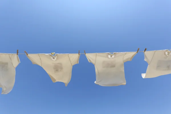 White t-shirts hanging to dry