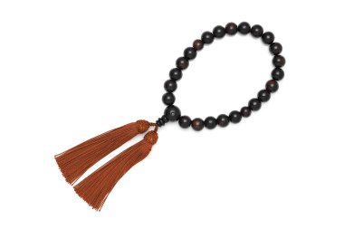 Juzu adında bir Budist tespihi. Cenazede namaz kılmak için kullanılan Budist aleti. 