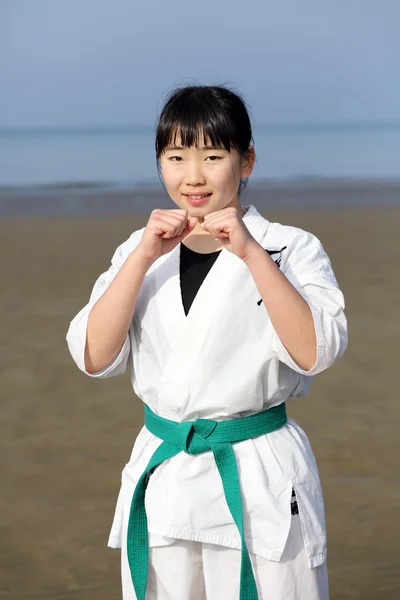 Japanese karate girl at the beach — Stock Photo, Image