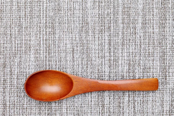 Wooden spoon on tablecloth — Stock Photo, Image