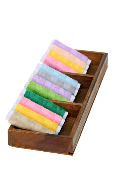 Colorful threads in wooden box — Stock Photo, Image