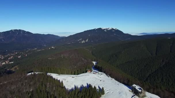 Luftbild Flug über Wald und Hügel mit Bergkette auf Hintergrund — Stockvideo
