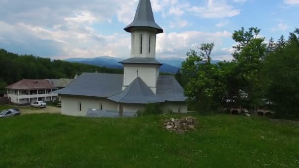 Christelijke kerk op de top van groene heuvel, luchtfoto, camera stijgen — Stockvideo