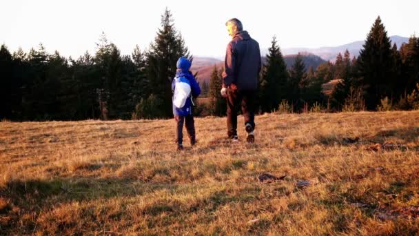 Father and son on a hike, top of the hill in autumn — Stock Video