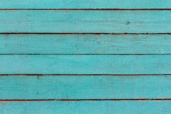 Ahşap zemin, eski ahşap duvar, maviye boyanmış, yarıklar ve çivilerle.