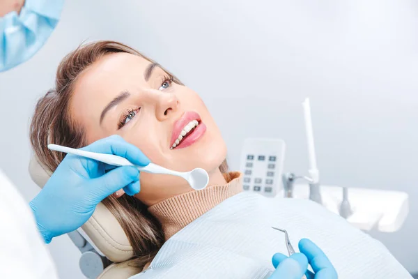 Attractive smiling woman at the dentist appointment